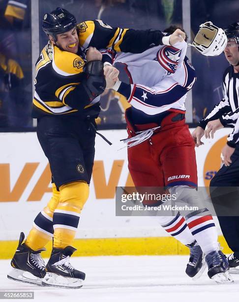 Milan Lucic of the Boston Bruins fights with Dalton Prout of the Columbus Blue Jackets in the second period during the game at TD Garden on November...