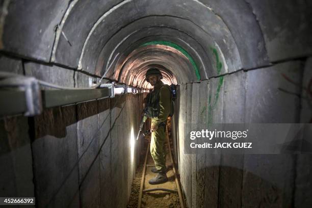 An Israeli army officer walks on July 25, 2014 during an army-organised tour in a tunnel said to be used by Palestinian militants from the Gaza Strip...