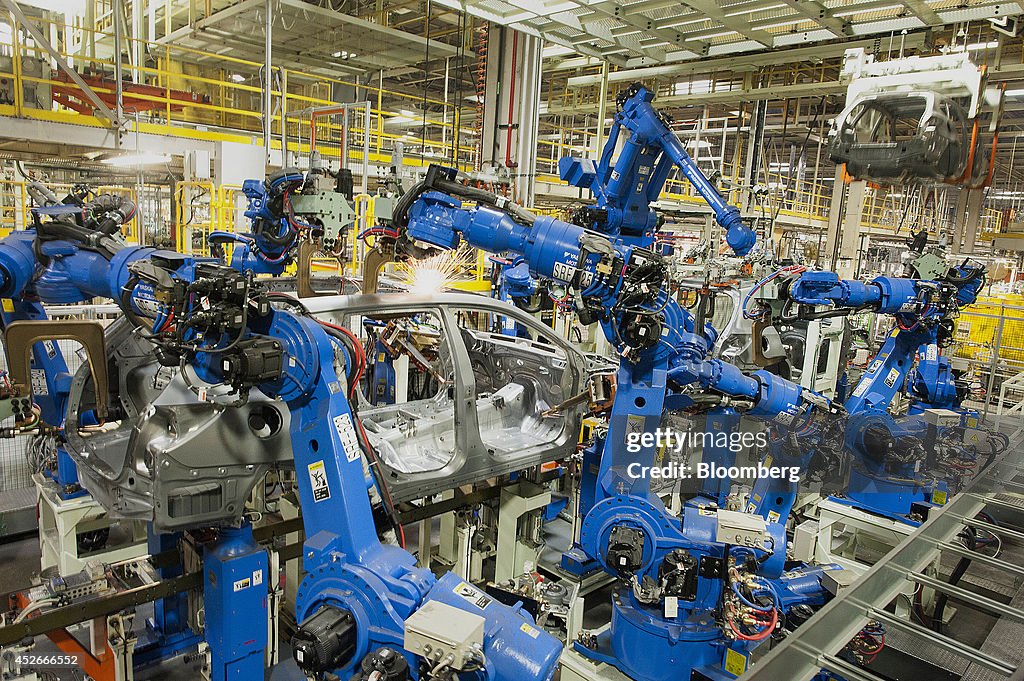 Subaru Assembly Line Robots weld together stamped out metal parts at the Subaru of Indiana ...