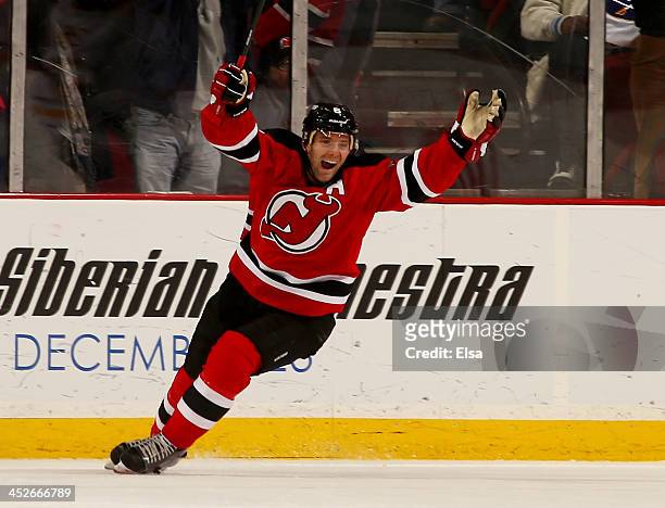 Andy Greene of the New Jersey Devils celebrates his teammate's game winning goal in overtime against the Buffalo Sabres at Prudential Center on...