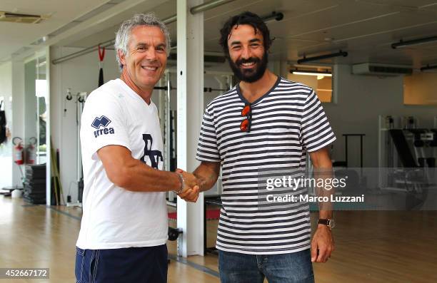 New signing Mattia Cassani shakes hands with Parma FC coach Roberto Donadoni before FC Parma Training Session at the club's training ground on July...