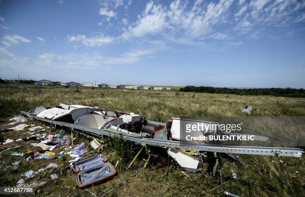 Picture shows a piece of debris of the fuselage and passengers' belongings at the crash site of the Malaysia Airlines Flight MH17 near the village of...