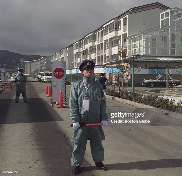 Nagano Police Officer stands watch at the entrance to the Olympic Village which houses the athletes for the 18th Winter Olympic Games. Security has...