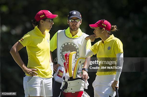 Spanish golfers Carlotta Ciganda and Azahara Munoz talk with their caddie during the second round of the LGPA International Crown at Caves Valley...