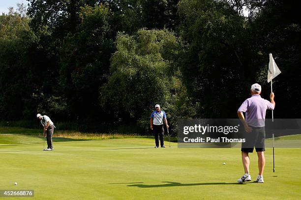 Mark Roberts of High Legh Golf Club putts while being watched by team mate Matthew Dixon during The Lombard Trophy North West Regional Qualifier at...