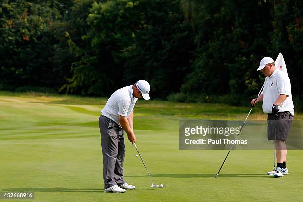 Jamie Goodhall of Glossop & District Golf Club putts while being watched by team mate Jason Eyre during The Lombard Trophy North West Regional...