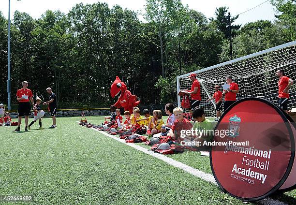 Ian Rush ambassador of Liverpool FC and Mighty Red mascot of Liverpool FC attends a Soccer School on July 25, 2014 in Newton, Massachusetts.