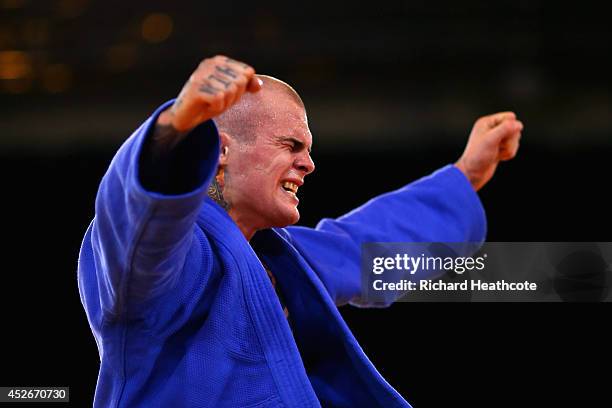Danny Williams of England celebrates winning gold in the Men's -73kg Final - Gold Medal Contest against Adrian Leat of New Zealand at SECC Precinct...