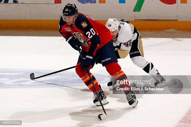 Sean Bergenheim of the Florida Panthers skates with the puck against Joe Vitale of the Pittsburgh Penguins at the BB&T Center on November 30, 2013 in...