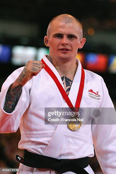 Gold medalist Danny Williams of England celebrates during the medal ceremony for the Men's -73kg Judo at SECC Precinct during day two of the Glasgow...