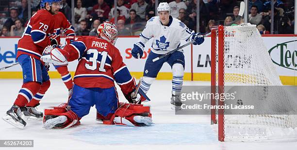 Mason Raymond of the Toronto Maple Leafs scores the second goal on Carey Price of the Montreal Canadiens while Andrei Markov defends the goal during...