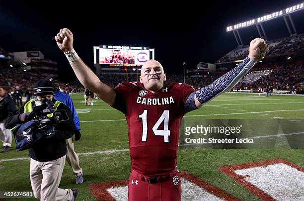 Connor Shaw of the South Carolina Gamecocks celebrates after defeating the Clemson Tigers 31-17 at Williams-Brice Stadium on November 30, 2013 in...