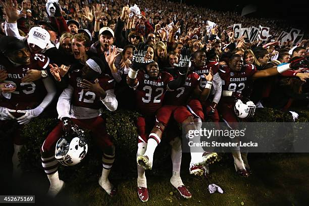 The South Carolina Gamecocks celebrate with students after a 31-17 victory over the Clemson Tigers after their game at Williams-Brice Stadium on...