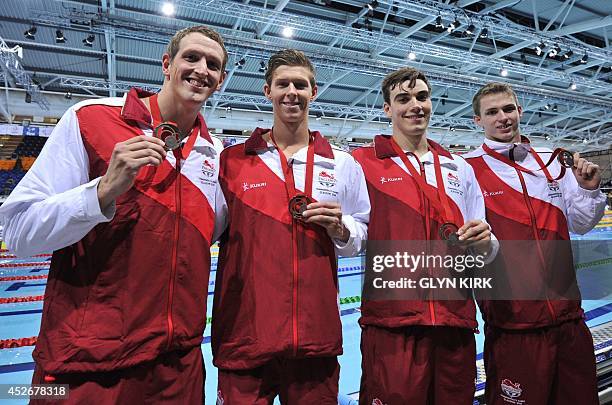 Bronze medallists England's Adam Brown, James Disney-May, Adam Barrett and Benjamin Proud poses during the Men's 4x100m Freestyle relay medal...