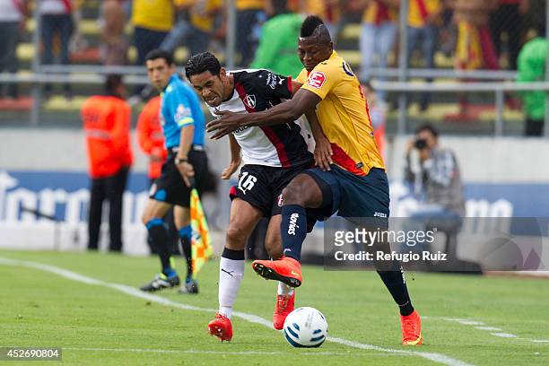 Amaury Ponce of Atlas fights for the ball with Duvier Riascos of Morelia during a match between Morelia and Atlas as part of 2nd round Apertura 2014...