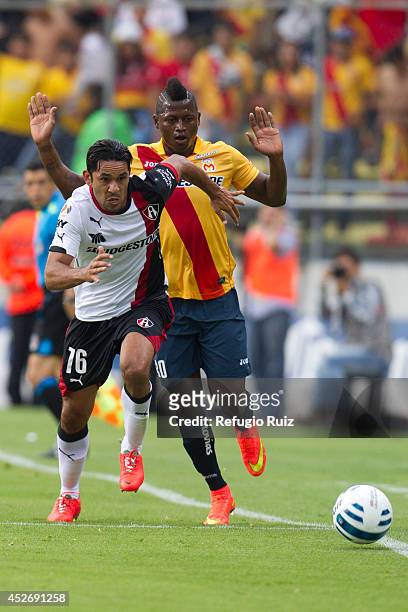 Amaury Ponce of Atlas runs for the ball as Duvier Riascos of Morelia tries to avoid the foul during a match between Morelia and Atlas as part of 2nd...