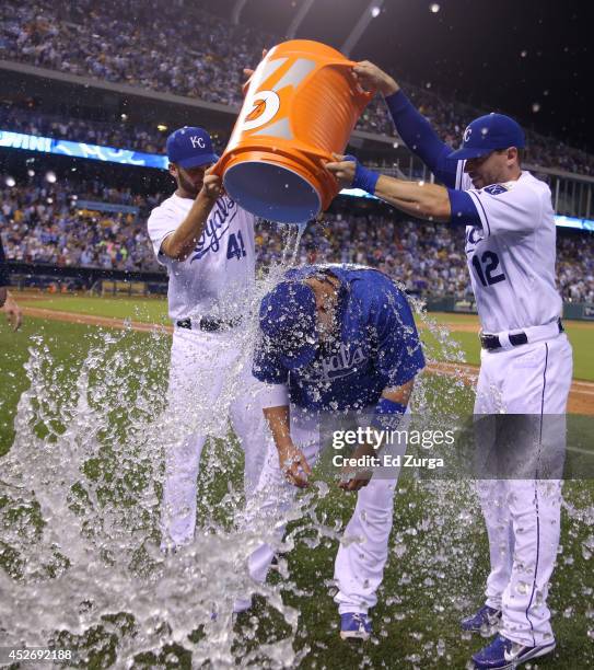 Billy Butler of the Kansas City Royals is doused with water by Danny Duffy and Brett Hayes after a 6-4 win over the Cleveland Indians at Kauffman...