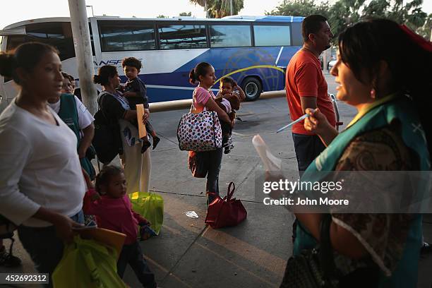 Central American immigrants just released from U.S. Border Patrol detention wait at the Greyhound bus station for their trip to Houston on July 25,...