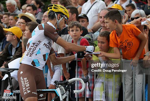 Blel Kadri of France and AG2R La Mondiale signs autographs for young fans prior to the start of the eighteenth stage of the 2014 Tour de France, a...