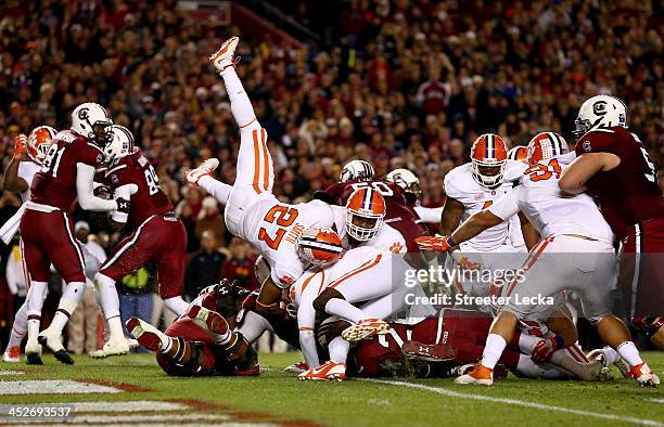 Mike Davis of the South Carolina Gamecocks dives for a touchdown as Robert Smith of the Clemson Tigers flips over during their game at Williams-Brice...