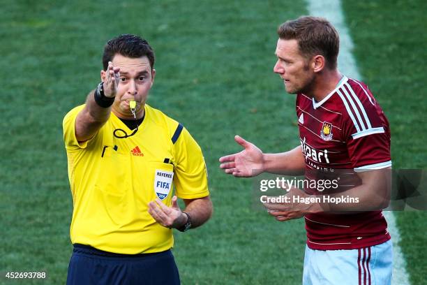 Referee Nick Waldron makes a call while Kevin Nolan of West Ham United pleads his case during the Football United New Zealand Tour 2014 match between...