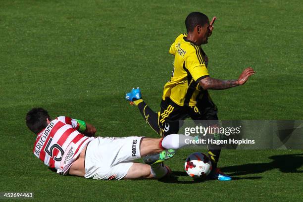 Kenny Cunningham of the Phoenix is brought down in the tackle of Michael Beauchamp of the Wanderers during the round eight A-League match between the...