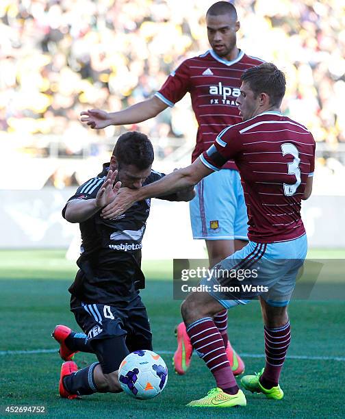 Pedj Bojic of Sydney FC is tackled by Aaron Cresswell of West Ham United as Winston Reid of West Ham United looks on during the Football United New...