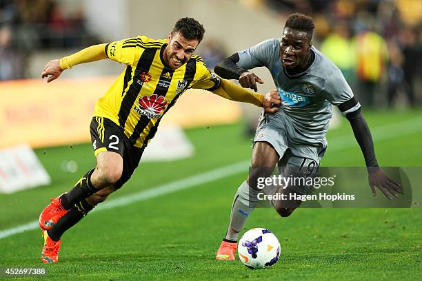 Manny Muscat of the Phoenix holds off Massadio Haidara of Newcastle United during the Football United New Zealand Tour 2014 match between the...