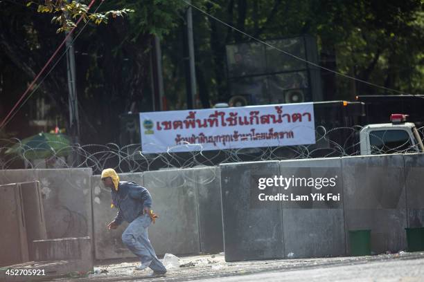 Anti-government protesters face off against riot police as they try to remove a barricade and occupy the government house on December 1, 2013 in...