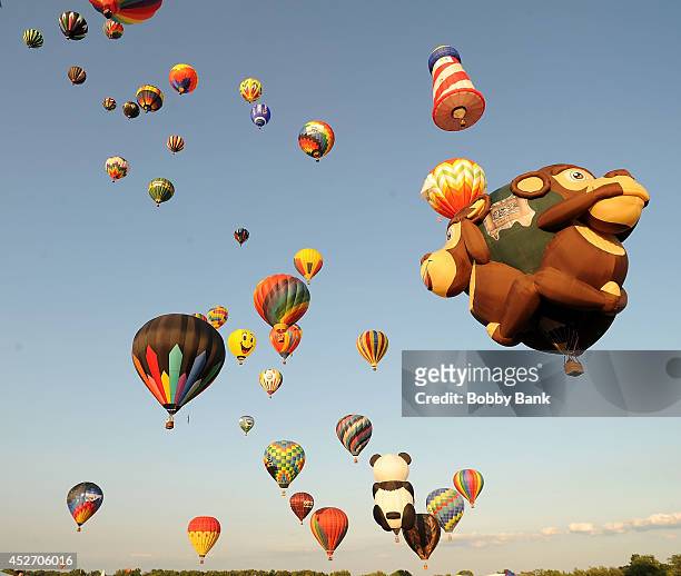 Sunset mass ascension of the 100 colorful sport and special shaped hot air balloons at the 2014 Quick Chek New Jersey Festival of Ballooning at...