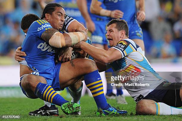 Fuifui Moimoi of the Eels is tackled during the round 20 NRL match between the Gold Coast Titans and the Parramatta Eels at Cbus Super Stadium on...
