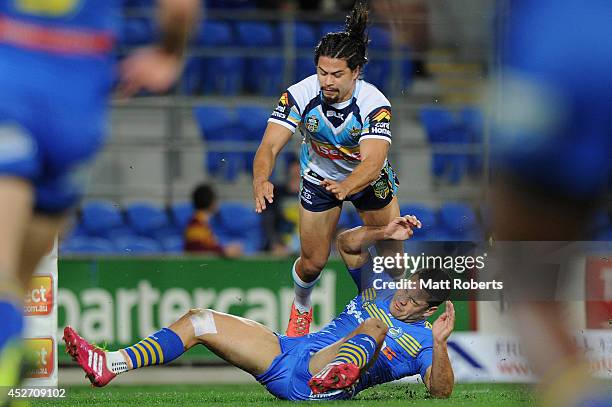 Jarryd Hayne of the Eels falls into Kevin Gordon of the Titans after a tackle attempt during the round 20 NRL match between the Gold Coast Titans and...