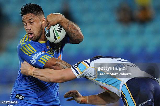 Kenny Edwards of the Eels is tackled during the round 20 NRL match between the Gold Coast Titans and the Parramatta Eels at Cbus Super Stadium on...