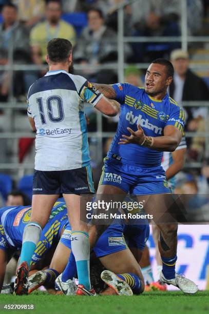 Junior Paulo of the Eels pushes Nate Myles of the Titans during the round 20 NRL match between the Gold Coast Titans and the Parramatta Eels at Cbus...