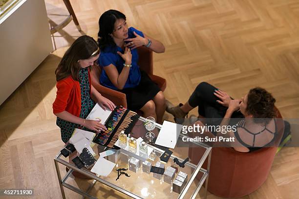 Customers interact with Yosh Han at Barney's New York on July 25, 2014 in Seattle, Washington.