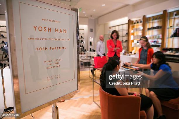 Customers interact with Yosh Han at Barney's New York on July 25, 2014 in Seattle, Washington.