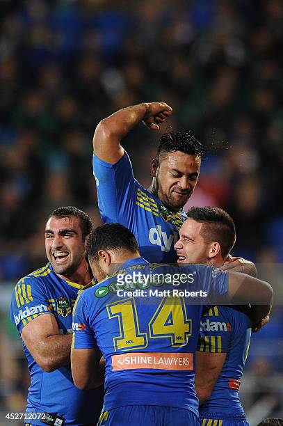 Corey Norman of the Eels celebrates scoring a try with team mates during the round 20 NRL match between the Gold Coast Titans and the Parramatta Eels...