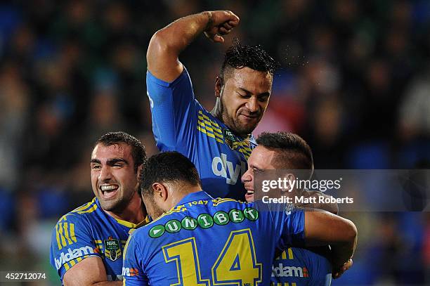 Corey Norman of the Eels celebrates scoring a try with team mates during the round 20 NRL match between the Gold Coast Titans and the Parramatta Eels...