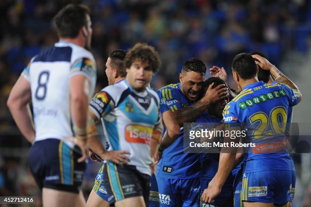 Chris Sandow of the Eels celebrates with team mates after a try by Corey Norman during the round 20 NRL match between the Gold Coast Titans and the...