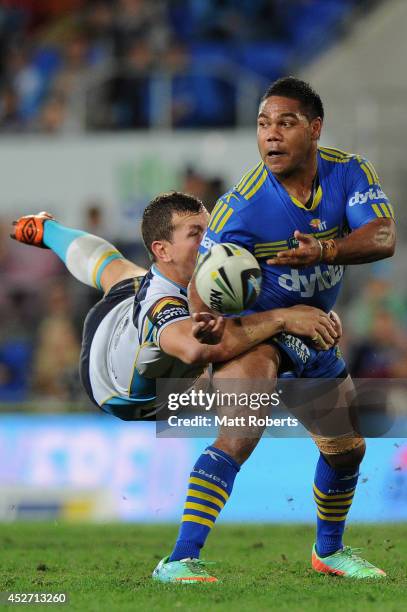 Chris Sandow of the Eels is tackled by Greg Bird of the Titans during the round 20 NRL match between the Gold Coast Titans and the Parramatta Eels at...