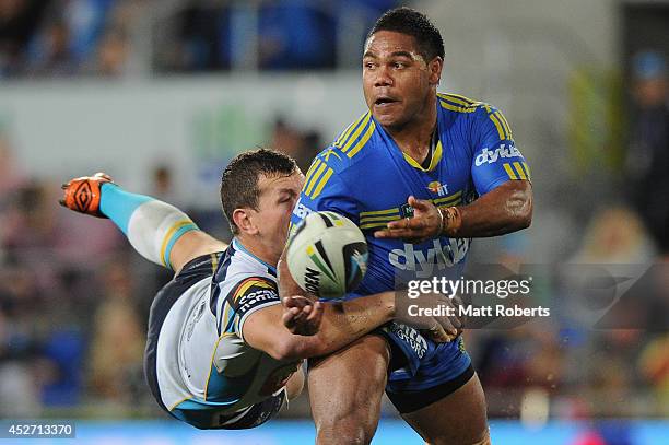 Chris Sandow of the Eels is tackled by Greg Bird of the Titans during the round 20 NRL match between the Gold Coast Titans and the Parramatta Eels at...