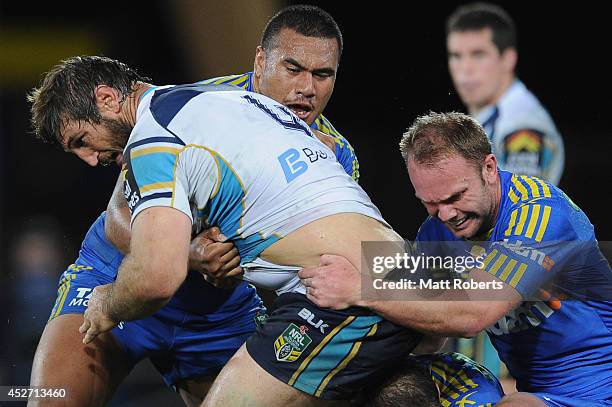 David Taylor of the Titans is tackled during the round 20 NRL match between the Gold Coast Titans and the Parramatta Eels at Cbus Super Stadium on...