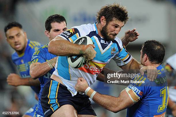 David Taylor of the Titans is tackled during the round 20 NRL match between the Gold Coast Titans and the Parramatta Eels at Cbus Super Stadium on...