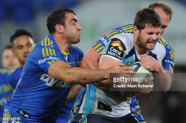 Anthony Don of the Titans is tackled during the round 20 NRL match between the Gold Coast Titans and the Parramatta Eels at Cbus Super Stadium on...