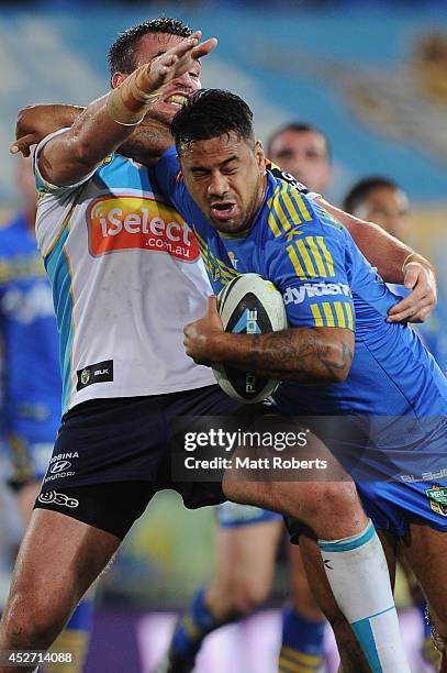 Kenny Edwards of the Eels is tackled during the round 20 NRL match between the Gold Coast Titans and the Parramatta Eels at Cbus Super Stadium on...