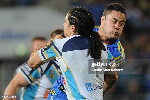 Jarryd Hayne of the Eels is tackled during the round 20 NRL match between the Gold Coast Titans and the Parramatta Eels at Cbus Super Stadium on July...