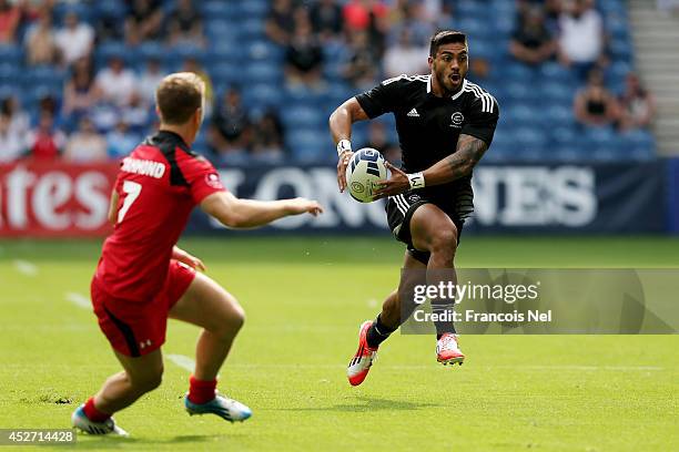 Pita Akhi of New Zealand takes on Lucas Hammond of Canada in the Rugby Sevens match between New Zealand and Canada at Ibrox Stadium during day three...