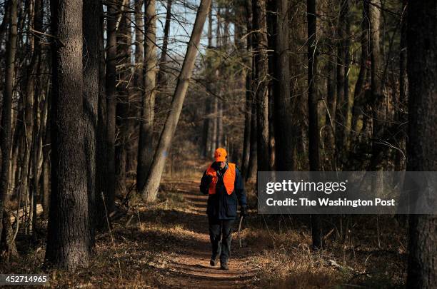 Volunteer, Jerry Peters walks on a trail after he and others tried to flush out deer during a deer hunt at Conway Robinson Memorial State Forest on...