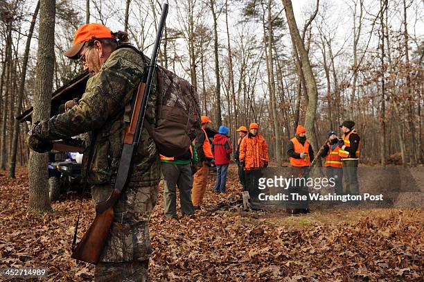 Ricky Goad, left, prepares to leave Conway Robinson Memorial State Forest after taking part in a deer hunt on Monday November 25, 2013 in...