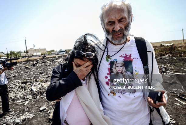 Angela Rudhart-Dyczynski and Jerzy Dyczynski from Australia react as they arrive on July 26, 2014 at the crash site of the Malaysia Airlines Flight...